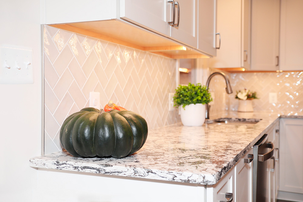 Elegant granite countertops and tiled glass backsplash.