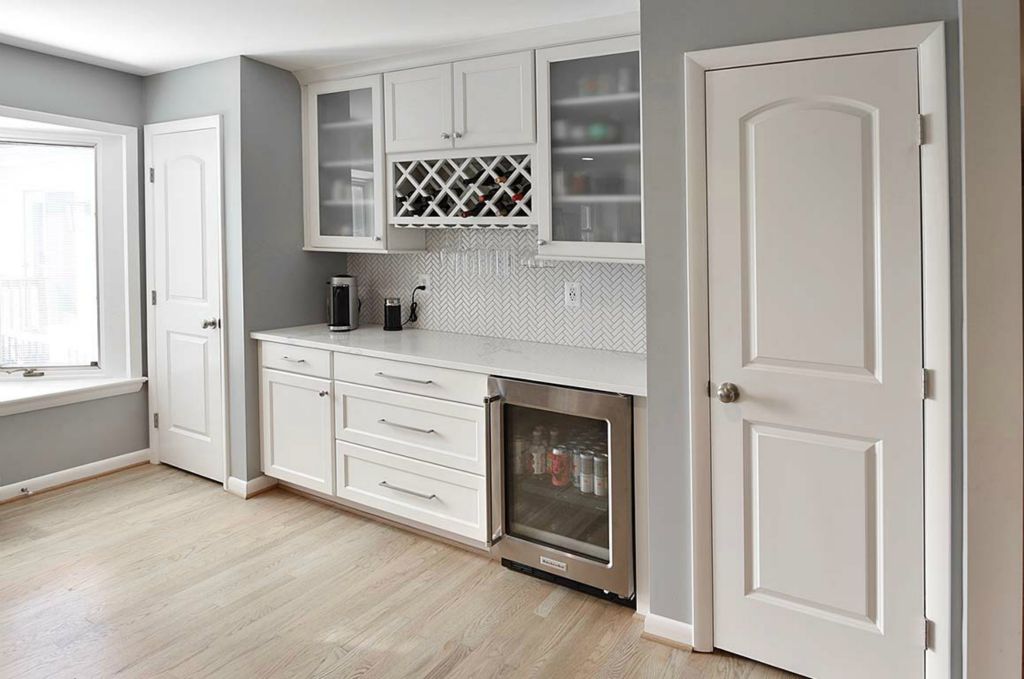 Wine bar with ample pantry space. Note the herringbone tile backsplash.